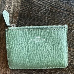Coach Green and Black Leather Keychain Wallet has a little damage in the photos